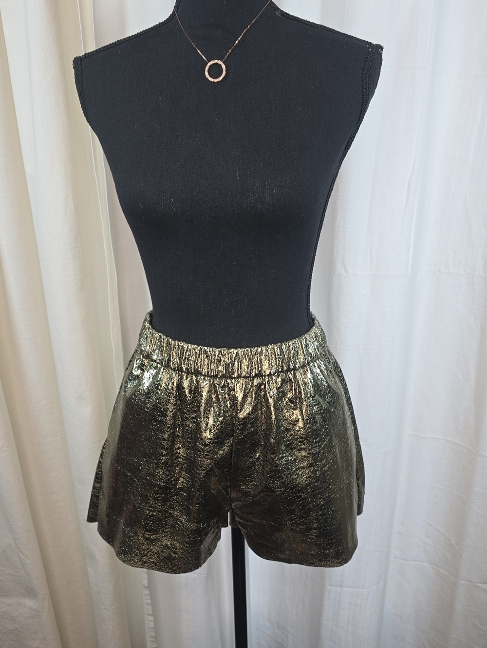 Metallic gold textured shorts featuring an elasticated waistband
